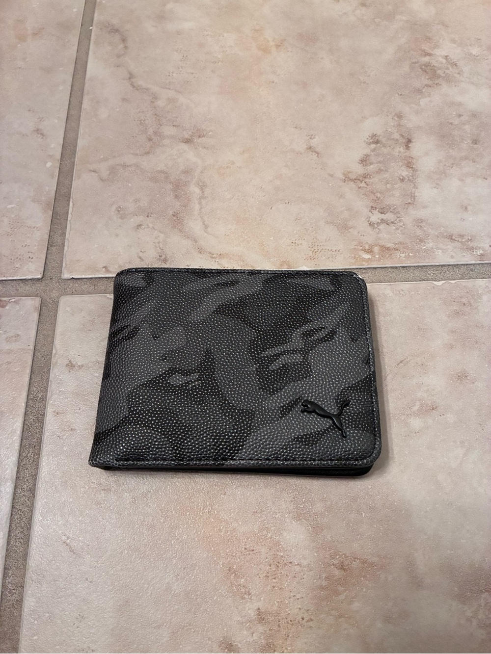 PUMA men’s bifold wallet in black camouflage pattern with PUMA logo.